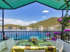 a table on a balcony with a view of the water at Apartment Rubin-8 by Interhome in Zastražišće