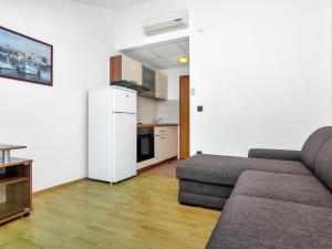 a living room with a couch and a white refrigerator at Apartment Rubin-8 by Interhome in Zastražišće +15 photos