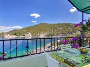 a balcony with a table and a view of the water at Apartment Rubin-8 by Interhome in Zastražišće