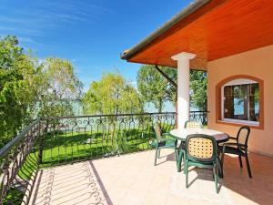 a patio with a table and chairs on a balcony at Apartment Lakefront 1 by Interhome in Balatonlelle