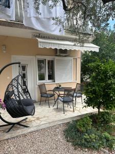 a patio with a table and chairs in front of a house at Apartment Antea in Šibenik