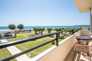 a balcony with a view of the beach at Al Mare Apartments in Afantou