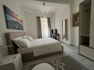 a bedroom with a white bed and a window at Casa L'Aquila in Como