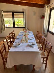 a long table with chairs and a white table cloth at Agriturismo Azzarone in Vieste