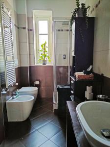 un bagno con lavandino, WC e vasca di Elegant Smart Suite with Free Parking a Torino