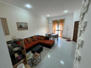 a living room with a couch and a table at Villa Franca on sea in Mazara del Vallo