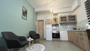 a kitchen with two chairs and a table in a room at Casa di Giovanna in Volos