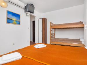 a bedroom with a bed and bunk beds with a television at Apartment Cico-2 by Interhome in Gdinj