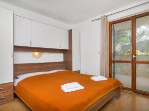a bedroom with a bed with two towels on it at Apartment Cico-2 by Interhome in Gdinj +7 photos