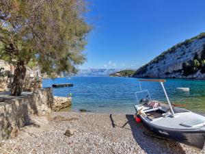 a small boat on the shore of a body of water at Apartment Cico-2 by Interhome in Gdinj
