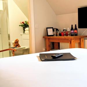 a bedroom with a bed with a remote control on it at Ben Cruachan Inn in Loch Awe