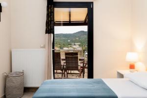 a bedroom with a bed and a view of a room at Marina View Syvota in Sivota