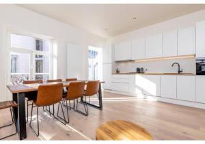 a kitchen with a table and chairs in a room at The Heart of Leuven in Leuven