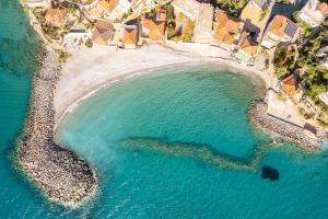 an aerial view of a beach with blue water at Avia's Seaside Hideaway with Lush Garden in Avia