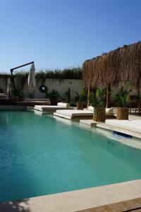 a swimming pool with blue water in a resort at The May Five - Adults only in Seferihisar +43 photos