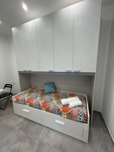 a bedroom with a bed with white cabinets at Sermoneta10 in Naples