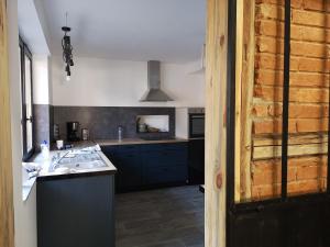 a kitchen with a sink and a counter top at Au 19 de Lina in Hoerdt