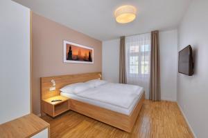 Cama o camas de una habitación en Downtown Suites Kodanska