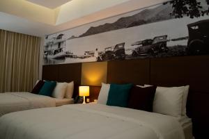 a hotel room with two beds and a picture of cars at Hotel Manantial Valencia in Valencia +53 photos