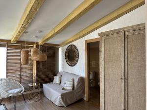 a room with a bed and a chair and a mirror at Botanico Beauty Boutique Hotel SPA in Jávea