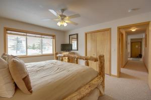 a bedroom with a bed and a ceiling fan at Condo in Cedar Creek with Shuttle to Big Sky Resort! in Gallatin Gateway