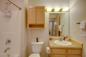 a bathroom with a toilet and a sink and a mirror at Condo in Cedar Creek with Shuttle to Big Sky Resort! in Gallatin Gateway +19 photos