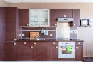 a kitchen with wooden cabinets and a sink at GuestReady - Modern chic with a view in La Défense