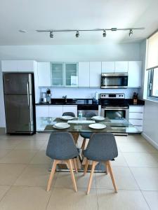 a kitchen with a table and chairs and a refrigerator at Monte Carlo Suites in Miami Beach in Miami Beach +47 photos