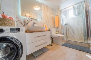 a bathroom with a washing machine and a washer at Efi's Luxury Apartment in Kavala +25 photos