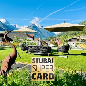 a sign that says surgical super card with chairs and umbrellas at Aparthotel Krösbacher in Fulpmes