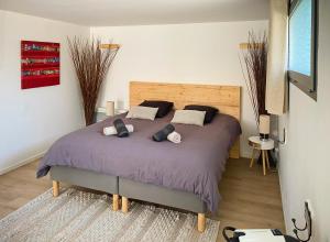 a bedroom with a large bed with two pillows at La Villa Hossegor in Hossegor