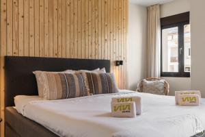 a bedroom with a large bed with two boxes on it at ViVi Homes - El Sembrador Pool, Terrace & Golf in La Cala de Mijas