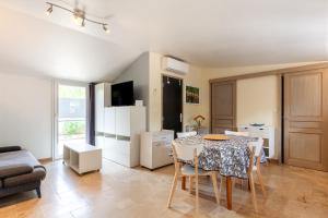 a kitchen and living room with a table and chairs at Pleine nature in Six-Fours-les-Plages