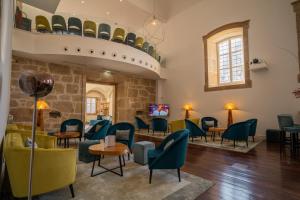 a waiting room with green chairs and tables at Convento do Seixo Boutique Hotel & Spa in Fundão