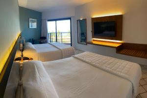 Cama ou camas em um quarto em HOTEL PIRÂMIDE NATAL
