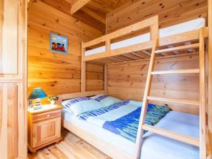 a bedroom with two bunk beds in a log cabin at Domki Romka in Mikołajki +37 photos