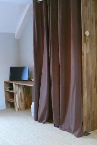a curtain in a room next to a desk with a laptop at Brise Marine in Erquy