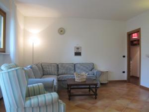 a living room with a couch and a table at Apartment Adelaide by Interhome in Albisano