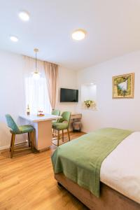 a hotel room with a bed and a desk and chairs at Luxury App PALACE OLD TOWN& Studio Green Melody with TERACCE in Split