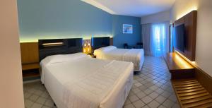 Cama ou camas em um quarto em HOTEL PIRÂMIDE NATAL