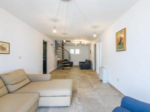 a living room with a couch and a table at Holiday Home Veronica by Interhome in Cecina