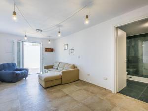 a living room with a couch and a chair at Holiday Home Veronica by Interhome in Cecina +51 photos