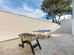 a ping pong table on a patio next to a wall at Holiday Home Veronica by Interhome in Cecina