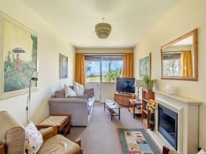 a living room with a couch and a tv at Beach View Cottage in Felixstowe