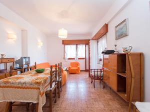 a living room with a table and a dining room at Apartment Giuliana by Interhome in Torvaianica