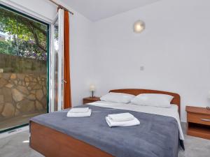 a bedroom with a bed with two towels on it at Apartment Rubin-2 by Interhome in Zastražišće