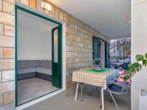 a patio with a table and chairs and a couch at Apartment Rubin-2 by Interhome in Zastražišće +14 photos