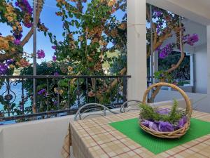 a basket on a table on a balcony with flowers at Apartment Rubin-2 by Interhome in Zastražišće