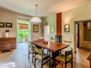 a kitchen and dining room with a wooden table and chairs at Holiday Home La Rina by Interhome in Dervio