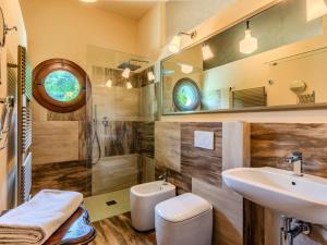 a bathroom with a sink and a shower and a toilet at Holiday Home La Rina by Interhome in Dervio